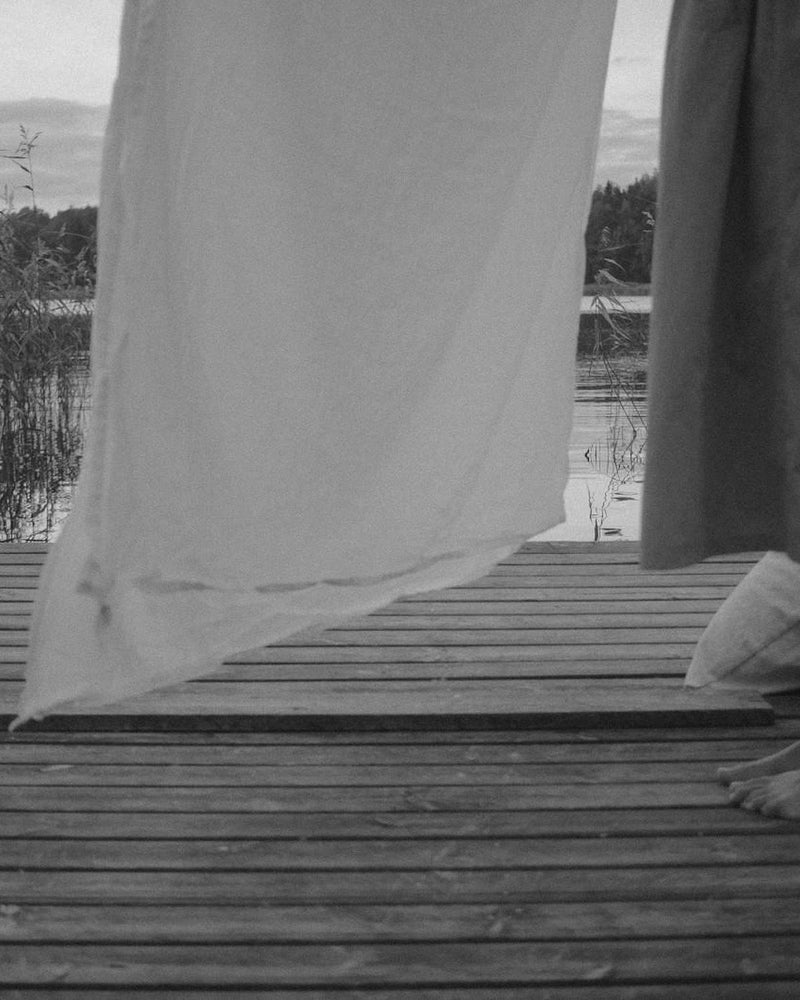 Linen drying on a line by the water